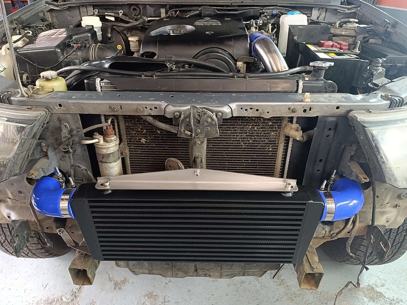 Large front-mounted performance intercooler installed by SNIPER Racing